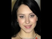 Sandra luberc is sited on a sofa, legs appart and looking at you