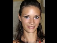 Anelly is sited on a sofa, legs appart and looking at you