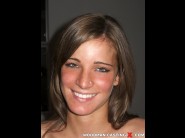 Virag lewis is sited on a sofa, legs appart and looking at you