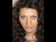 Nikita bulgaria is sited on a sofa, legs appart and looking at you