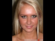 Jessy tiger is sited on a sofa, legs appart and looking at you