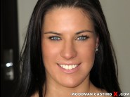 Athina is sited on a sofa, legs appart and looking at you