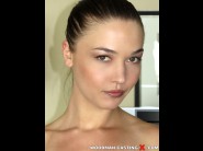 Angelik duval is sited on a sofa, legs appart and looking at you