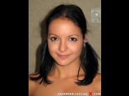 Sandra bina is sited on a sofa, legs appart and looking at you