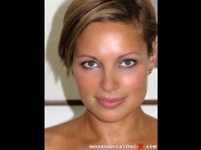 Szilvia lauren is sited on a sofa, legs appart and looking at you