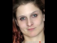 Kreatris is sited on a sofa, legs appart and looking at you