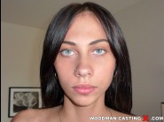 Kamilla is sited on a sofa, legs appart and looking at you