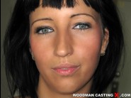 Henriett is sited on a sofa, legs appart and looking at you