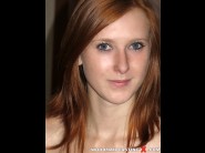 Linda sweet is sited on a sofa, legs appart and looking at you