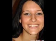 Yulia bright is sited on a sofa, legs appart and looking at you