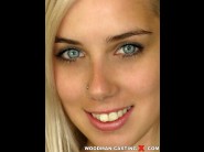 Nesty is sited on a sofa, legs appart and looking at you