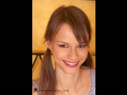 Beata undine is sited on a sofa, legs appart and looking at you