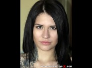 Erika bellucci is sited on a sofa, legs appart and looking at you