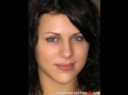 Scarlett jons is sited on a sofa, legs appart and looking at you