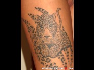 Dorina sweet is sited on a sofa, legs appart and looking at you