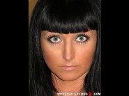 Anastasia is sited on a sofa, legs appart and looking at you