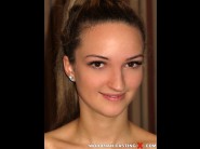 Vicky braun is sited on a sofa, legs appart and looking at you