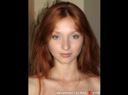 Michelle h is sited on a sofa, legs appart and looking at you