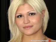 Kitty rich is sited on a sofa, legs appart and looking at you