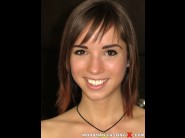 Tina hot is sited on a sofa, legs appart and looking at you