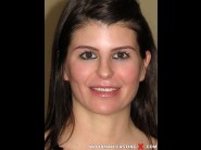 Suzy schweider is sited on a sofa, legs appart and looking at you