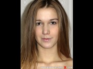 Alexis crystal is sited on a sofa, legs appart and looking at you