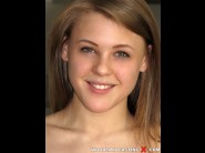 Viola bailey's is sited on a sofa, legs appart and looking at you