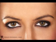 Mela is sited on a sofa, legs appart and looking at you