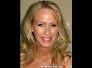  is sited on a sofa, legs appart and looking at you