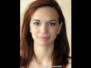 Shafry is sited on a sofa, legs appart and looking at you