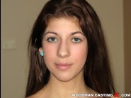 Elis gilbert is sited on a sofa, legs appart and looking at you