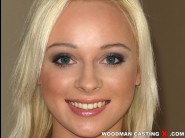 Naomi nevena is sited on a sofa, legs appart and looking at you