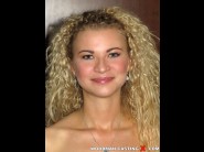 Angel diamonds is sited on a sofa, legs appart and looking at you