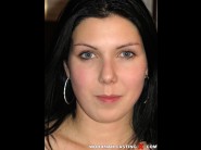 Lilia rouge is sited on a sofa, legs appart and looking at you