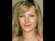 Ogzija is sited on a sofa, legs appart and looking at you