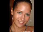 Terenza loy is sited on a sofa, legs appart and looking at you