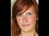 Dasy is sited on a sofa, legs appart and looking at you