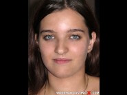 Brooke azure is sited on a sofa, legs appart and looking at you