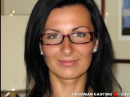 Lara is sited on a sofa, legs appart and looking at you