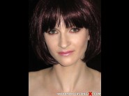 Araya kiss is sited on a sofa, legs appart and looking at you