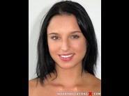 Anni mal is sited on a sofa, legs appart and looking at you