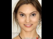 Victoria roswell is sited on a sofa, legs appart and looking at you