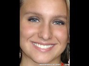 Nessy nesso is sited on a sofa, legs appart and looking at you