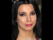 Melody ghost is sited on a sofa, legs appart and looking at you