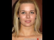 Nikky dream is sited on a sofa, legs appart and looking at you