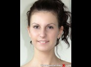 Liloo tatoo is sited on a sofa, legs appart and looking at you