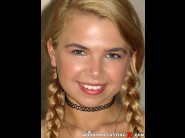 Alina west is sited on a sofa, legs appart and looking at you