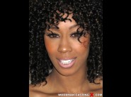 Misty stone is sited on a sofa, legs appart and looking at you