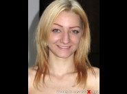 Betty lynn is sited on a sofa, legs appart and looking at you