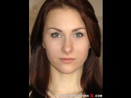 Alice marshall is sited on a sofa, legs appart and looking at you